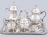 <span class='ref_item'>105 -</span> <span class="object_title">JUEGO DE TÉ Y CAFÉ DE METAL PLATEADO CON BANDEJA. </span>   <p><span class="technique_material">Metal plateado</span><br><span class="technical_description">Compuesto por: Tetera, cafetera, lechera, azucarero, colador y bandeja. <br/>Ligeros desgastes. <br/>23 cm la cafetera. </span><br><span class="ALTO_HCES1">40 </span><span class="ALTOUMED_HCES1">cm.</span>x<span class="ANCHO_HCES1">30 </span><span class="ANCHOUMED_HCES1">cm.</span></p>