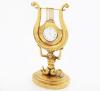 <span class='ref_item'>99 -</span> <span class="object_title">SOPORTE EN LATÓN DORADO CON RELOJ DE BOLSILLO DE CUERDA MANUAL. ALEMANIA, S.XIX</span>   <p><span class="technique_material">Bronce  </span><br><span class="technical_description">En forma de lira sostenida por una melusina de dos colas sobre peana. <br/>Inscripción en la base "Sr. Hochwürden derri Herri Seminardirector Dr.Barnich, Bitter zur 25 jährichen Amts Fubeltier 22 juni 1837"<br/>Con reloj de bolsillo realizado en metal dorado de movimiento de cuerda manual. En estado de marcha</span><br><span class="PESO_HCES1">582,50 </span><span class="PESOUMED_HCES1">gr.</span><br><span class="ALTO_HCES1">24 </span><span class="ALTOUMED_HCES1">cm.</span></p>