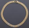 <span class='ref_item'>18 -</span>  <span class="object_title">GARGANTILLA REALIZADA EN ORO BICOLOR DE 18 KT Y DIAMANTES </span><br><span class="technical_description">Gargantilla en oro bicolor de 18 kt. tipo " Panthere" acompañada de diamantes en talla brillante de peso total aprox. 0.10 ct.</span>  