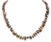 <span class='ref_item'>98 -</span> <span class="object_title">COLLAR GARGANTILLA DE ORO BAJO Y CUARZO OJO DE TIGRE</span>  <p><span class="technical_description">Collar gargantilla realizado en oro bajo con piezas de cuarzo ojo de tigre alternando con bolitas de oro.<br/>Cierre: Mosquetón<br/>Longitud: 42cm</span><br>Peso: <span class="PESO_HCES1">25,30</span> <span class="PESOUMED_HCES1">gr.</span><br></p>
