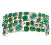 <span class='ref_item'>114 -</span> <span class="object_title">PULSERA ANCHA EN ORO BICOLOR 18KT, ESMERALDAS Y DIAMANTES</span>  <p><span class="technical_description">Pulsera ancha semirrígida, realizada en oro bicolor de 18kt. Cuajada de esmeraldas en su talla y en talla oval y redonda, con peso total aprox 56ct y diamantes en talla brillante con peso total aprox 4.45ct. Todo engastado en garras con vistas en blanco.<br/>Cierre: Caja con lengüeta y doble ocho de seguridad<br/>Medidas: 18 x 3cm</span><br>Peso: <span class="PESO_HCES1">86,30</span> <span class="PESOUMED_HCES1">gr.</span><br></p>