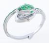 <span class='ref_item'>65 -</span> <span class="object_title">RELOJ DE PULSERA EN METAL PLATEADO, CRISTALES VERDES E INCOLOROS. CUARZO</span>  <p><span class="technical_description">Reloj de pulsera en metal plateado de la marca Cussi, con movimiento de cuarzo. Forma de serpiente cuajada por cristales verdes en tallas marquise, baguette y trapecio, y cristales incoloros en talla brillante. Debajo de la cabeza de la serpiente se encuentra la esfera del reloj. Brazalete abierto semirrígido. En estado de marcha.<br/>Diámetro: 7cm</span><br>Peso: <span class="PESO_HCES1">46,30</span> <span class="PESOUMED_HCES1">gr.</span><br></p>