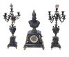 <span class='ref_item'>255 -</span> <span class="description">GUARNICIÓN RELOJ Y CANDELABROS, BARCELONA S. XIX. </span>  <p><span class="description">Reloj decorado con el busto de la diosa Atenea en calamina con base cuadrada. Desperfecto en una esquina y está un poco suelta. <br>Cuerpo del reloj decorado con aplicaciones en bronce dorado de motivos egipcios. Esfera con tapa de cristal, de números romanos y sello de marca Brazalete Modern Barcelona. Con llaves para dar cuerda. Necesita revisión. Se acompaña por una pareja de candelabros en base cuadrada y cuerpo en forma de copa. Decorados con aplicaciones en metal dorado, algunas sueltas y con faltas. A uno de ellos le faltan dos brazos. <br>Medidas reloj: 64x32x18cm<br>Medidas candelabros: 70x13x12cm</span></p>