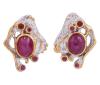<span class='ref_item'>165 -</span> <span class="object_title">PENDIENTES EN PLATA 925 CON CHAPADO EN ORO, RUBÍES Y GRANATES. JOYERÍA DE AUTOR, PIEZA ÚNICA</span>  <p><span class="technical_description">Pareja de pendientes realizados en plata de ley 925 con contrastes y partes chapadas en oro. Adornados por cabujones ovales de rubíes con peso total aprox 2.60ct, rodeados por pequeños granates en talla redonda con peso total aprox 0.10ct.<br/>Cierre: Omega</span><br>Peso: <span class="PESO_HCES1">9,20</span> <span class="PESOUMED_HCES1">gr.</span><br></p>
