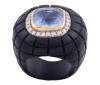 <span class='ref_item'>130 -</span> <span class="object_title">SORTIJA EN ÉBANO, ORO 18KT, ZAFIRO Y DIAMANTES</span>  <p><span class="technical_description">Sortija realizada en ébano. Con zafiro central en talla cojín con peso aprox 6.45ct engastado en bisel de oro de 18kt y rodeado de diamantes en talla brillante con peso total aprox 0.40ct.<br/>Medida Sortija: 12<br/>RefC 9272GP</span><br>Peso: <span class="PESO_HCES1">9,20</span> <span class="PESOUMED_HCES1">gr.</span><br></p>