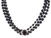 <span class='ref_item'>110 -</span> <span class="object_title">COLLAR DE SÍMIL DE AZABACHE</span>  <p><span class="technical_description">Collar de tres hilos formado por cuentas facetadas realizadas en símil de azabache, con cuenta mayor calibrada en 12mm. Broche en metal y cabujón de piedra negra<br/>Cierre: Caja con lengüeta<br/>Longitud: 70cm</span><br>Peso: <span class="PESO_HCES1">124</span> <span class="PESOUMED_HCES1">gr.</span><br></p>