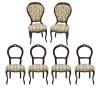 <span class='ref_item'>244 -</span> <span class="object_title">CONJUNTO DE 6 SILLAS EN MADERA DE NOGAL, ESTILO ISABELINO</span>   <p><span class="technical_description">Conjunto de 6 sillas de comedor realizadas en madera de nogal tallada en patas, reposabrazos y respaldo tipo cabriolé. Todas tapizadas en asiento con motivos florales y franjas verdes, y dos de ellas, con respaldo tapizado y abotonado. Presentan ligeros desgastes en la madera. Una de ellas con notables desperfectos.<br/>Medidas: 48x97x43cm<br/> <br/>Una de las sillas con respaldo presenta notables desperfectos </span><br></p>