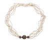 <span class='ref_item'>31 -</span> <span class="object_title">COLLAR CORTO CON SEIS HILOS TRENZADOS DE PERLAS CULTIVADAS EN AGUA DUCE Y BROCHE EN ORO DE 14 KT Y ESMALTE</span>  <p><span class="technical_description">Collar corto compuesto por seis hilos trenzados de perlas cultivadas en agua dulce alargadas como granos de arroz. Broche con forma esférica realizado en oro de 14 kt. y adornado por franjas con esmalte en azul cobalto.<br/>Cierre: Caja con lengüeta larga. Longitud: 42 cm</span><br>Peso: <span class="PESO_HCES1">44,70</span> <span class="PESOUMED_HCES1">gr.</span><br></p>