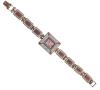 <span class='ref_item'>49 -</span> <span class="object_title">RELOJ EN PLATA DE LEY 925 Y BRONCE CON RUBIES Y CIRCONITAS. CUARZO</span>  <p><span class="technical_description">Reloj  realizado en plata de ley 925 y bronce con caja rectangular  y ventana de esfera de color carmesí y bisel ancho adornado por rubíes en los ángulos y cuajado de circonitas, medidas: 30mm x 26mm. Brazalete también adornado por rubíes y circonitas y con cierre de pestaña<br/>Longitud: 18 cm. Mecanismo de cuarzo. En funcionamiento.</span><br>Peso: <span class="PESO_HCES1">38,3</span> <span class="PESOUMED_HCES1">gr.</span><br></p>