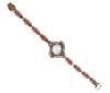 <span class='ref_item'>147 -</span> <span class="object_title">RELOJ EN PLATA DE LEY 925 Y BRONCE CON RUBIES, GRANATES , AMATISTAS Y CIRCONITAS. CUARZO</span>  <p><span class="technical_description">Reloj realizado en plata de ley 925 y bronce. Caja con forma romboidal con esfera en suave color dorado  y bisel adornado por granates y circonitas, medidas: 30mm x 30mm.Brazalete también adornado por rubíes, granates, amatistas y circonitas con cierre de pestaña y longitud de 18 cm<br/>Mecanismo de cuarzo, en funcionamiento</span><br>Peso: <span class="PESO_HCES1">32,5</span> <span class="PESOUMED_HCES1">gr.</span><br></p>