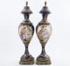 <span class='ref_item'>82 -</span> <span class="object_title">PAREJA DE JARRONES DE ESTILO SÈVRES EN PORCELANA Y BRONCE</span>   <p><span class="technical_description">Pareja de jarrones de estilo Sèvres en porcelana azul cobalto y bronce. Con escenas galantes románticas pintadas a mano en un medallón central y rodeadas de ricos detalles dorados. Con un relieve en la parte de atrás del escudo de armas. Fabricados por Salvador Mallol. Regalo del autor a su sobrina Doña María del Pilar Ximenez de Eubun Martín. Medidas: 48cm altura.</span><br></p>